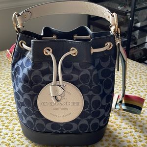 Coach denim crossbody never been used, with multi color wide strap